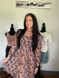western dress brown in color with mesh sleeves and a western print.