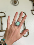 girl wearing a large sterling silver and turquoise ring. 